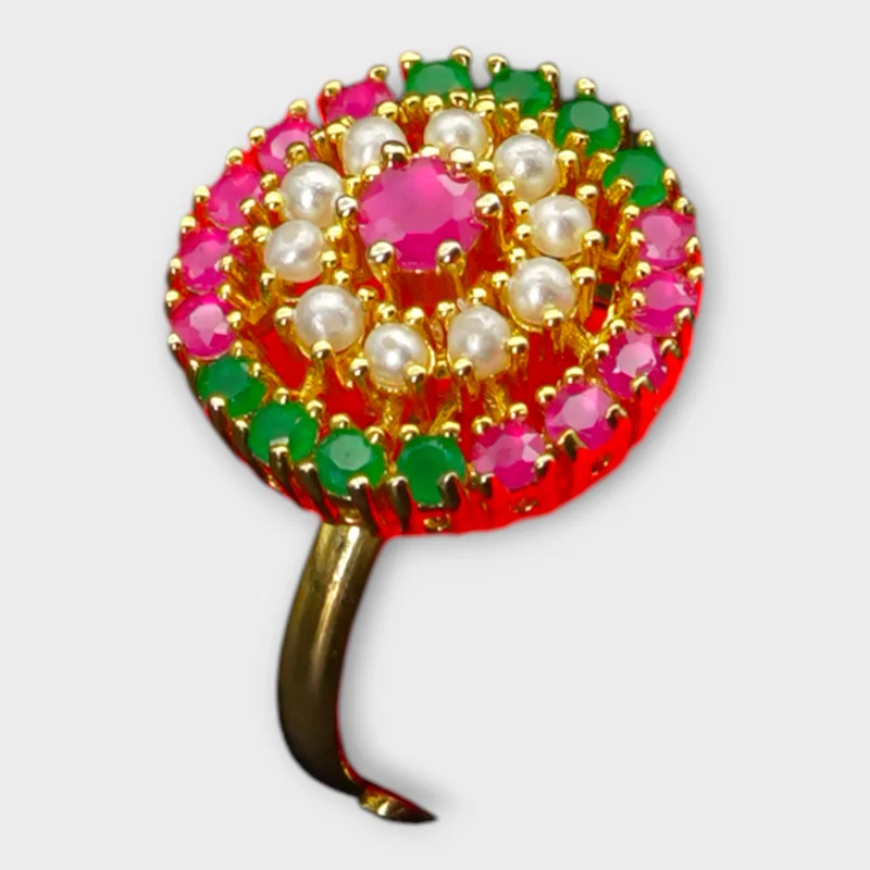 STONIRA high-dome gold cocktail ring featuring a central ruby surrounded by a white pearl halo and alternating rows of rubies and emeralds
