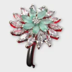 Top view of STONIRA silver cocktail ring featuring a central mint green gemstone flower surrounded by a dramatic starburst halo of clear marquise crystals