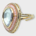 Angle view of STONIRA adjustable gold statement ring featuring a teardrop-cut central Kundan gem surrounded by peach beads and a micro-pave crystal halo