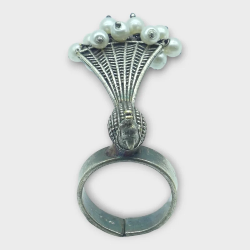 STONIRA adjustable statement ring featuring an oxidised silver peacock with a fan-shaped tail crowned in white pearls overview