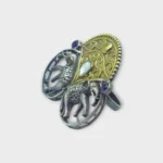 Side view of STONIRA adjustable mixed-metal cocktail ring featuring oxidized silver elephants, a golden archway, and sapphire crystal accents