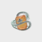 Top view of STONIRA adjustable silver cocktail ring featuring a rectangular orange cat's eye stone and crystal pavé ribbons