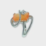 STONIRA adjustable silver cocktail ring featuring a rectangular orange cat's eye stone and crystal pavé ribbons