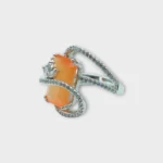 Side view of STONIRA adjustable silver cocktail ring featuring a rectangular orange cat's eye stone and crystal pavé ribbons
