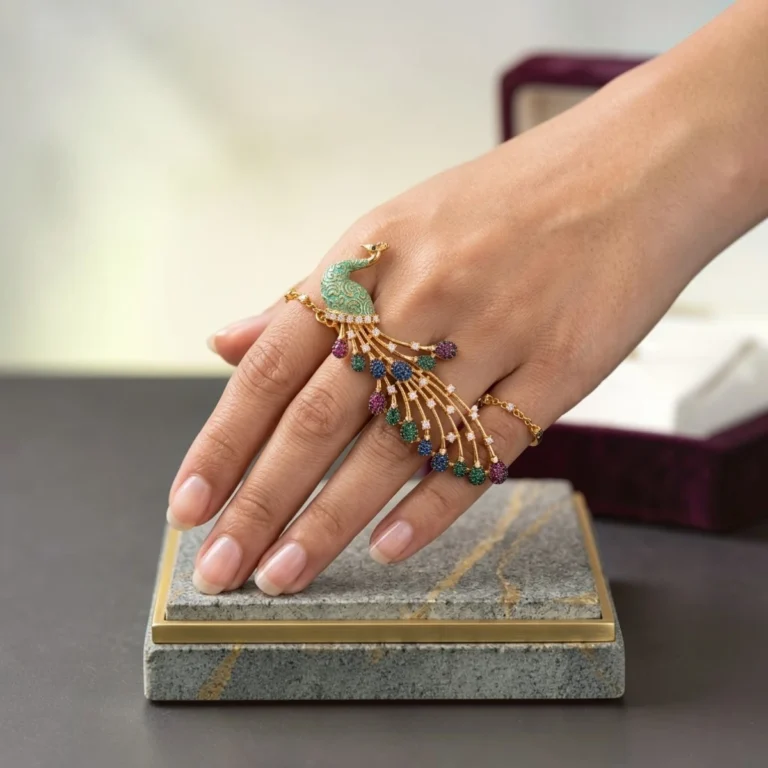 Women wearing STONIRA peacock-inspired adjustable two-finger statement ring featuring turquoise enamel detailing, multicolour crystal accents, gold-tone finish, and an elegant peacock feather design.