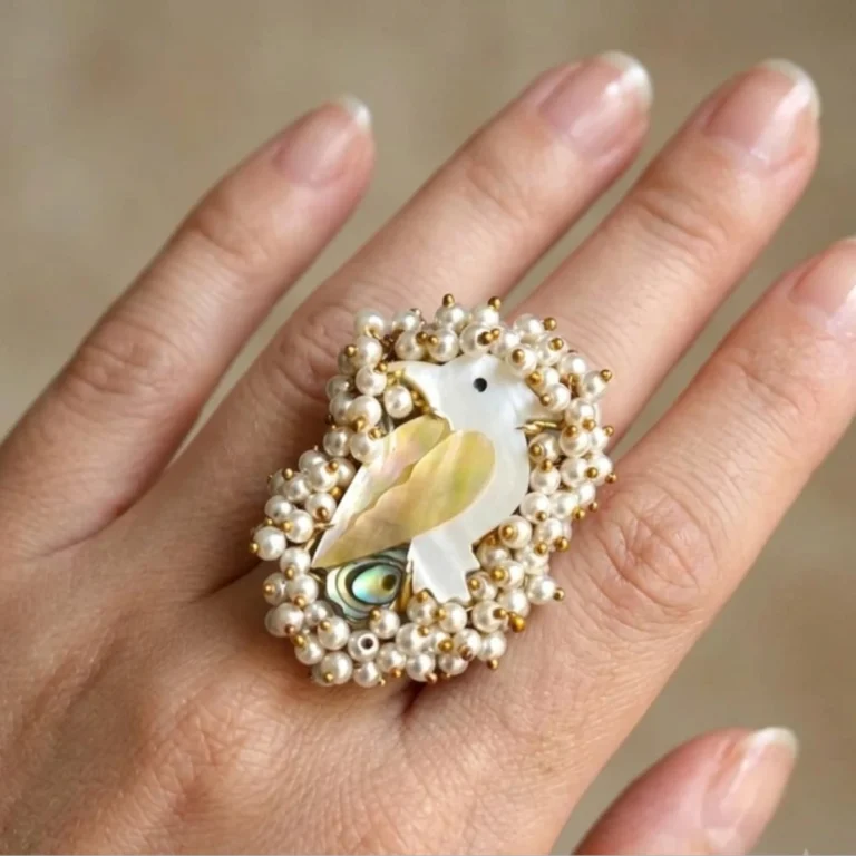 Women wearing Swan-inspired pearl statement ring in gold-tone finish