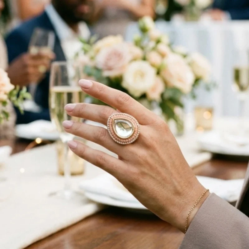 Women wearing STONIRA adjustable gold statement ring featuring a teardrop-cut central Kundan gem surrounded by peach beads and a micro-pave crystal halo