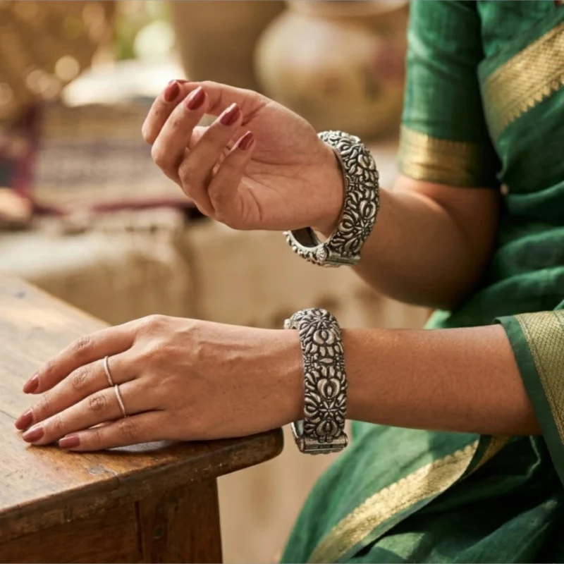 Detailed view of the STONIRA oxidised silver floral statement hinged bangle