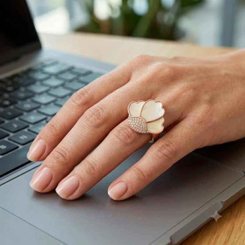 Women wearing STONIRA adjustable rose gold statement ring featuring a carved Mother of Pearl flower motif anchored by a micro-crystal pave cluster