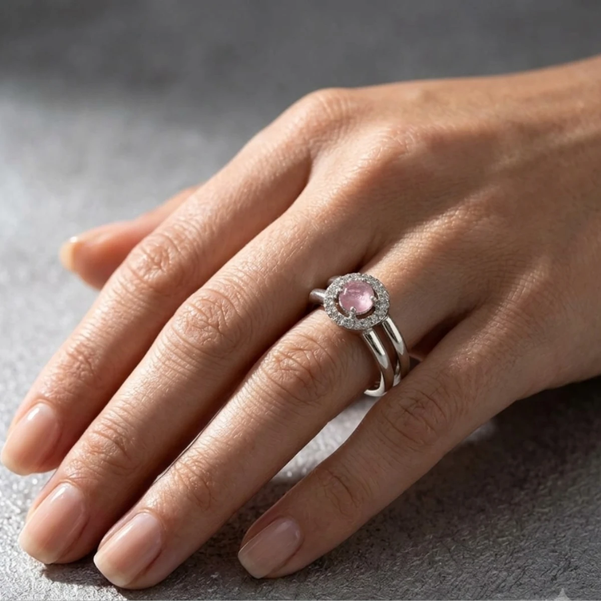 Gemini_Generated_Image_rryvt9rryvt9rryv Women wearing STONIRA pink quartz silver bypass ring with sparkling micro pave halo backdrop