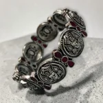 Overview of STONIRA oxidised silver coin statement bangle with pink stone inlays