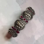 Top view of STONIRA oxidised silver coin statement bangle with pink stone inlays