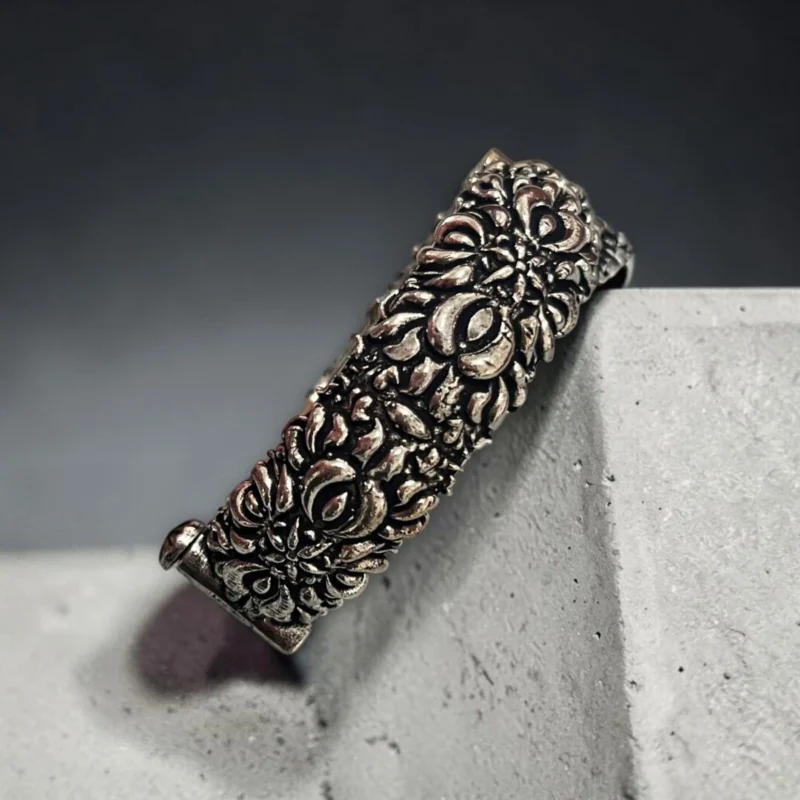 side view of the STONIRA oxidised silver floral statement hinged bangle