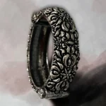 Detailed floral view of the STONIRA oxidised silver floral statement hinged bangle