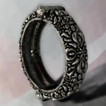 Detailed view with clasp of the STONIRA oxidised silver floral statement hinged bangle