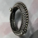 Side view of the STONIRA oxidised silver lattice hinged statement bangle