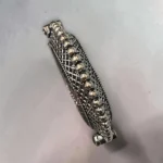 Top view of the STONIRA oxidised silver lattice hinged statement bangle