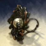 Side view of Artisan STONIRA peacock cocktail ring featuring an oversized central pearl and micro-paved colorful crystals