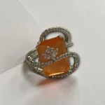 STONIRA adjustable silver cocktail ring featuring a rectangular orange stone and crystal pavé ribbons
