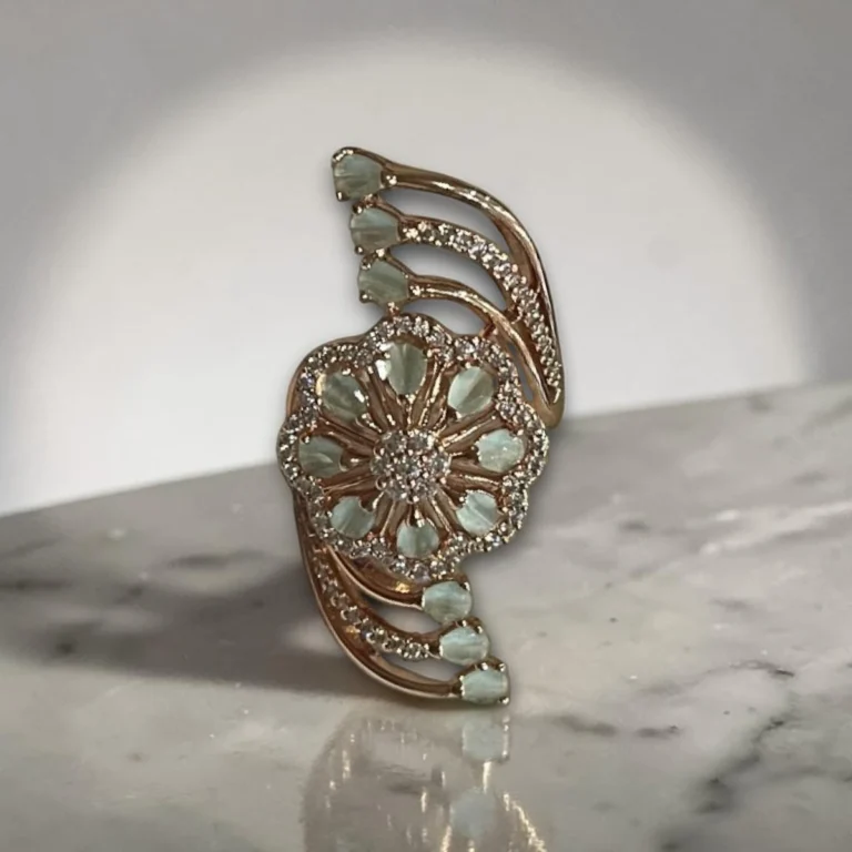 Women wearing STONIRA adjustable gold cocktail ring with a mint green stone floral rosette and crystal-paved arches