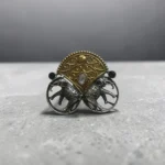STONIRA adjustable mixed-metal cocktail ring featuring oxidized silver elephants, a golden archway, and sapphire crystal accents