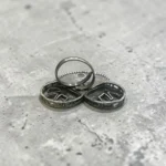 Back view of STONIRA adjustable mixed-metal cocktail ring featuring oxidized silver elephants, a golden archway, and sapphire crystal accents