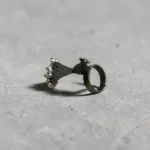 Side view of STONIRA adjustable statement ring featuring an oxidised silver peacock with a fan-shaped tail crowned in white pearls