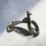 STONIRA adjustable statement ring featuring an oxidised silver peacock with a fan-shaped tail crowned in white pearls overview
