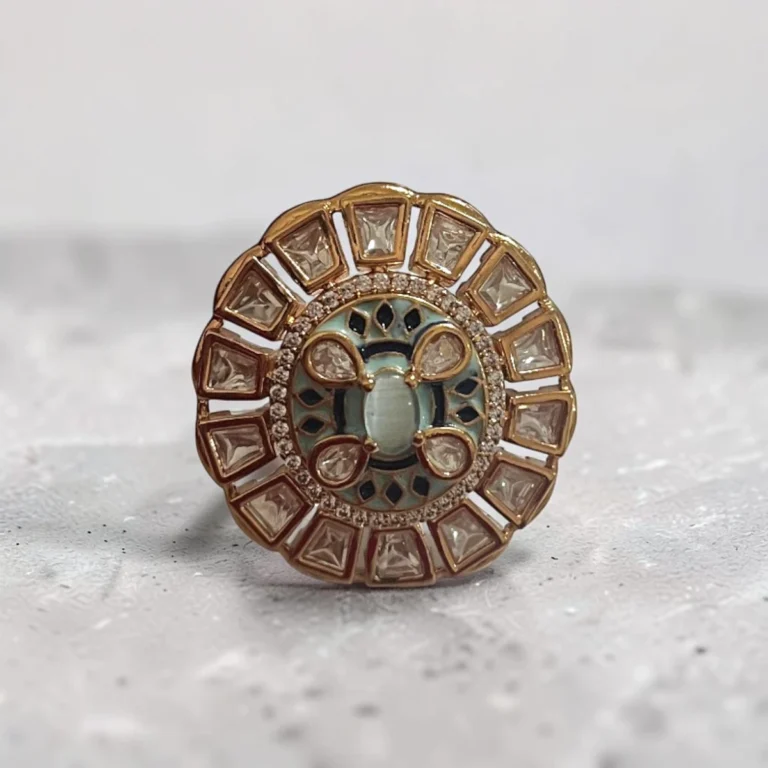 STONIRA adjustable gold medallion ring featuring a turquoise cat's eye center, blue enamel work, and a sunburst of geometric crystals