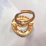 Back view of STONIRA adjustable gold statement ring featuring a teardrop-cut central Kundan gem surrounded by peach beads and a micro-pave crystal halo