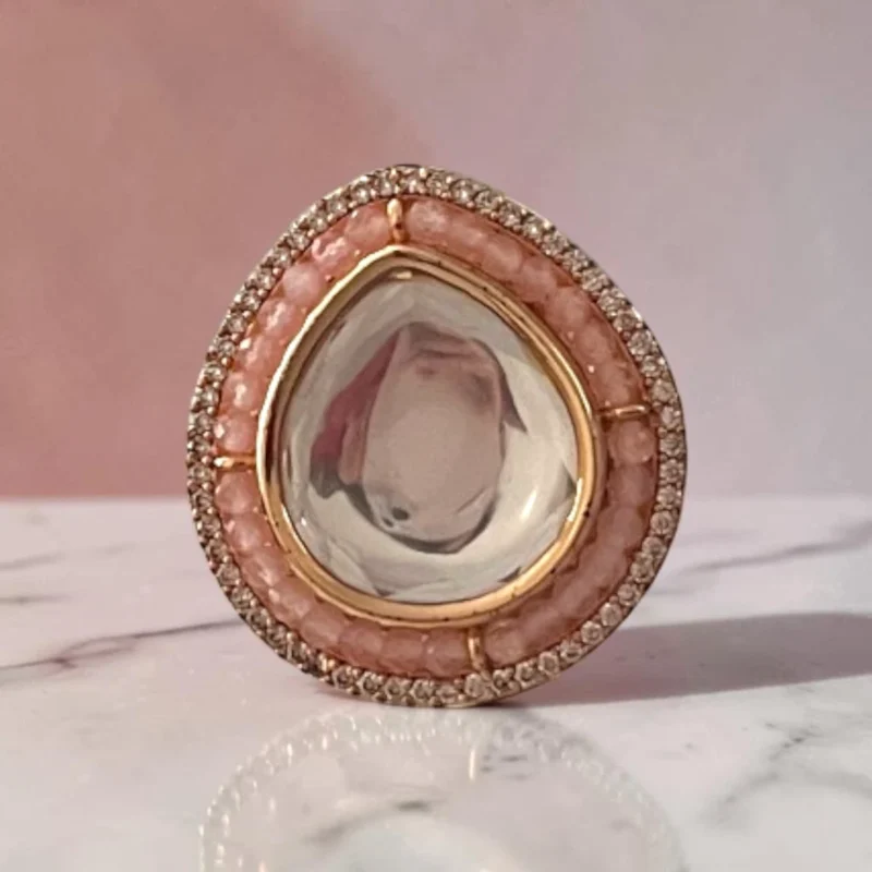 STONIRA adjustable gold statement ring featuring a teardrop-cut central Kundan gem surrounded by peach beads and a micro-pave crystal halo
