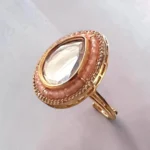 Side View of STONIRA adjustable gold statement ring featuring a teardrop-cut central Kundan gem surrounded by peach beads and a micro-pave crystal halo