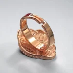 Back view of STONIRA adjustable rose gold statement ring featuring a carved Mother of Pearl flower motif anchored by a micro-crystal pave cluster