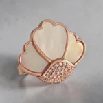 STONIRA adjustable rose gold statement ring featuring a carved Mother of Pearl flower motif anchored by a micro-crystal pave cluster
