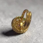 Back of STONIRA high-dome gold cocktail ring featuring a central ruby surrounded by a white pearl halo and alternating rows of rubies and emeralds