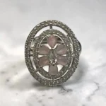 STONIRA silver cocktail ring with an oval pavé border featuring a central rose quartz flower and marquise-cut crystal bud