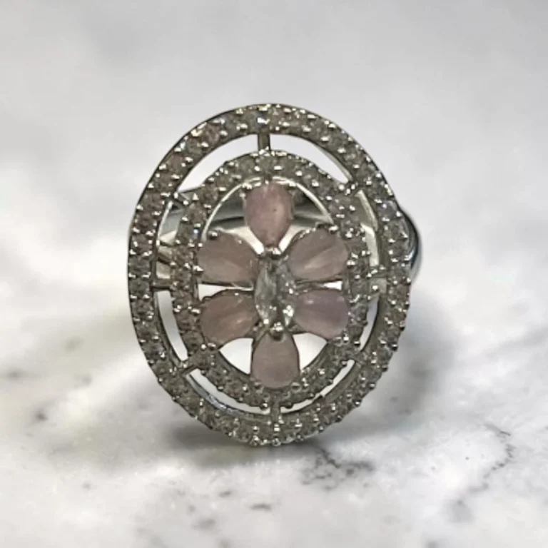 STONIRA silver cocktail ring with an oval pavé border featuring a central rose quartz flower and marquise-cut crystal bud