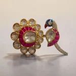 Gold tone peacock ring with pink enamel and kundan stones