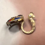 STONIRA peacock-inspired adjustable statement ring featuring multicolor enamel tail detailing, crystal embellishments, and a gold-tone finish.