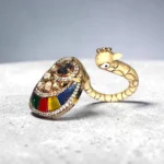 Side view of STONIRA peacock-inspired adjustable statement ring featuring multicolor enamel tail detailing, crystal embellishments, and a gold-tone finish.