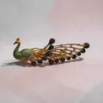 Overview of STONIRA peacock-inspired adjustable two-finger statement ring featuring turquoise enamel detailing, multicolour crystal accents, gold-tone finish, and an elegant peacock feather design.