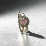 Modern sterling silver asymmetric open wrap ring with pink gemstone on female hand