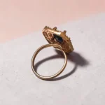 Back-view-of-the-STONIRA-rose-gold-polished-navy-blue-statement-ring-worn-on-a-hand-highlighting-the-deep-blue-rectangular-gemstone-and-double-crystal-halo