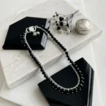 Hand-crafted silver black crystal bead anklet lying flat on stone tray by STONIRA