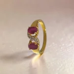 STONIRA-gold-plated-statement-ring-featuring-a-balanced-vertical-alignment-of-two-oval-ruby-pink-gemstones-connected-by-a-delicate-S-curve-of-clear-crystal-pave.