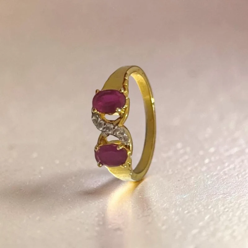 STONIRA-gold-plated-statement-ring-featuring-a-balanced-vertical-alignment-of-two-oval-ruby-pink-gemstones-connected-by-a-delicate-S-curve-of-clear-crystal-pave.