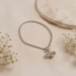 STONIRA-modern-silver-spherical-bead-payal-anklet-laid-in-a-neat-circle-on-textured-cream-paper