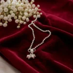 STONIRA-modern-silver-spherical-bead-payal-anklet-laid-on-smooth-fabric