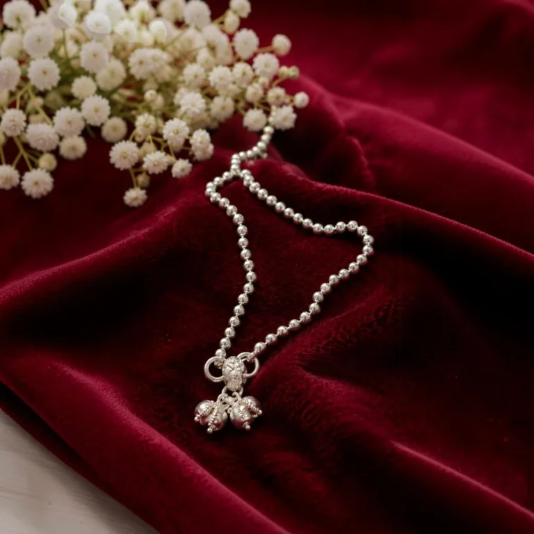 STONIRA-modern-silver-spherical-bead-payal-anklet-laid-on-smooth-fabric