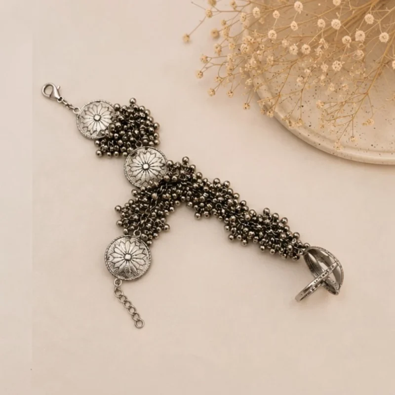 STONIRA oxidised silver floral hathphool hand harness bracelet featuring sunburst medallions and dense ghungroo bell clusters